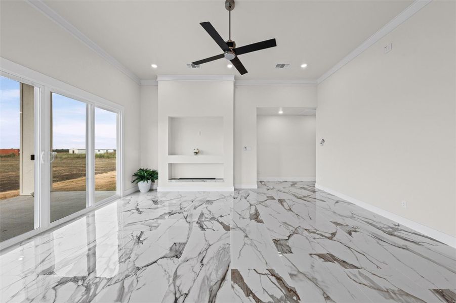 Gleaming polished tile floors and sliding glass doors define this open living space.