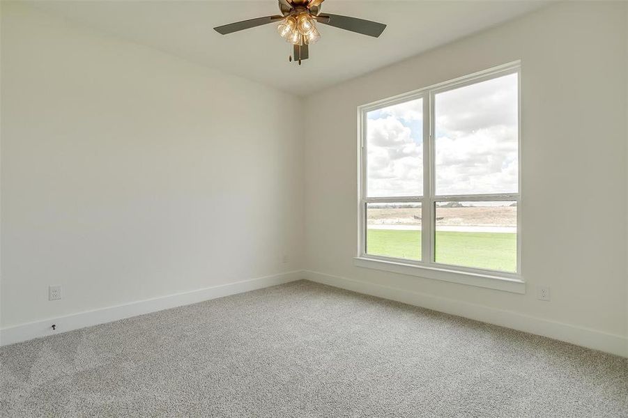 Unfurnished room with ceiling fan and carpet flooring