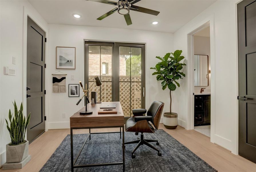 The first-floor study/bedroom 4 offers ensuite bathroom access and glass doors to the backyard. Virtually staged photo.