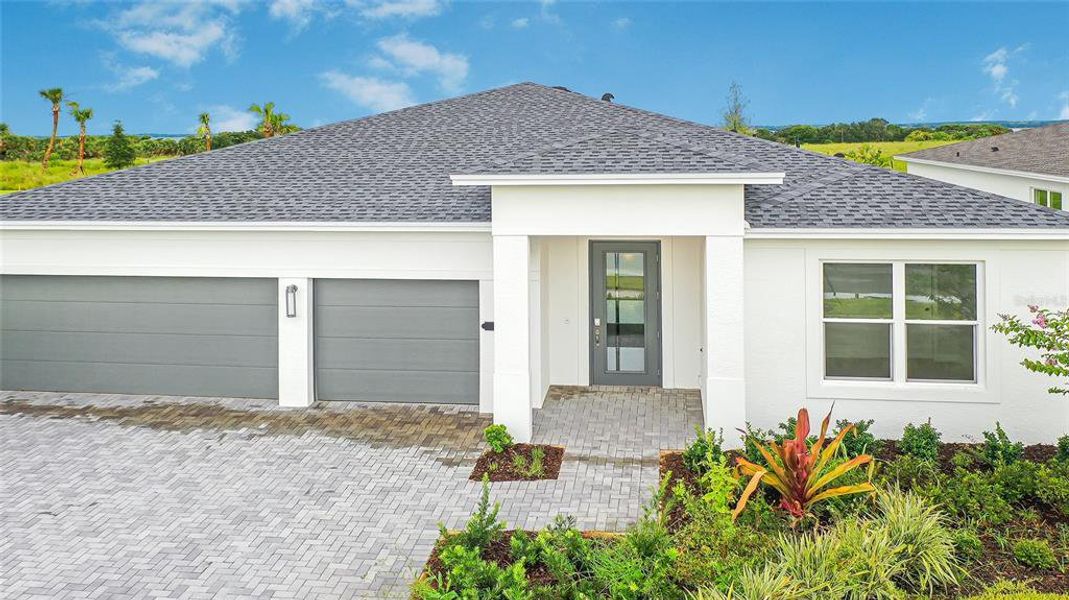 Front exterior of a new home in Cresswind at Lake Harris, Tavares, FL, highlighting curb appeal (Image 29).