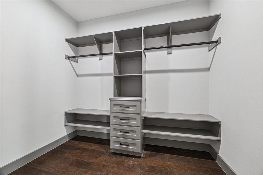 Shelves, drawers, and double hanging rods in the custom closet create an organized, versatile space for clothing, shoes, and accessories. Shelves, drawers, and double hanging rods in the custom closet create an organized, versatile space for clothing, shoes, and accessories.