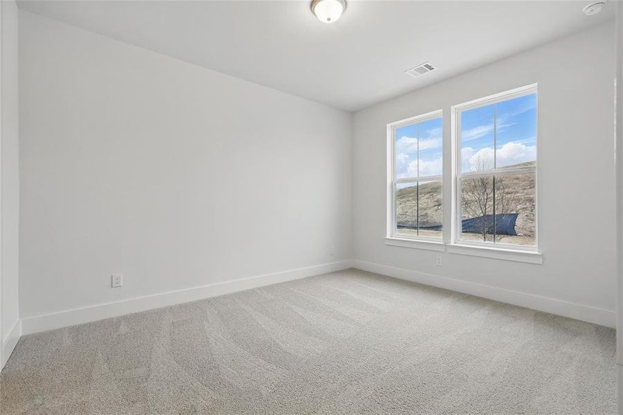 Spare room featuring light colored carpet