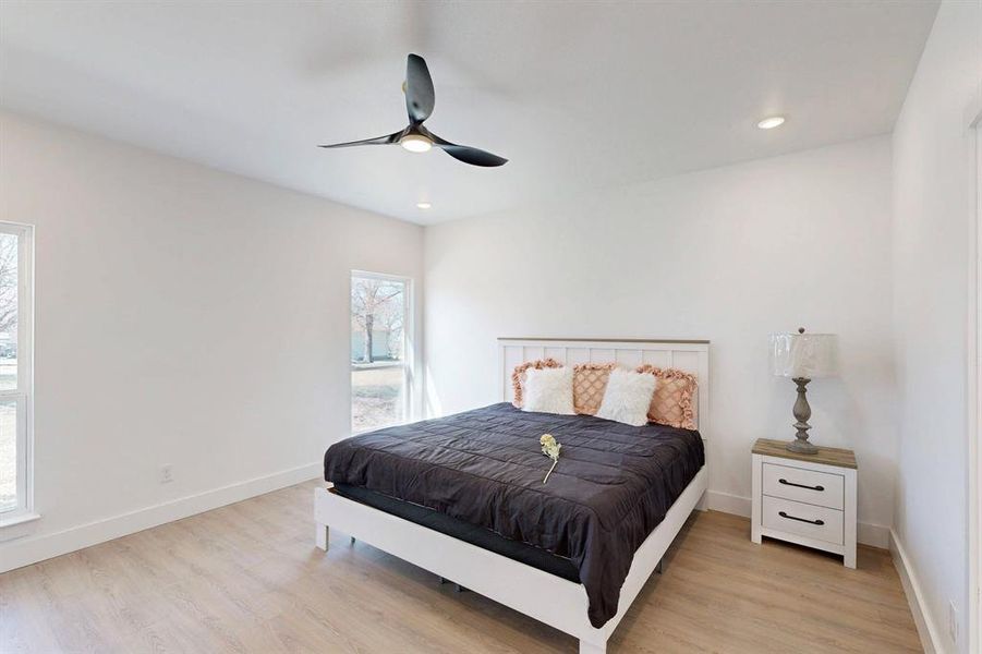 Bedroom featuring light hardwood / wood-style floors and ceiling fan