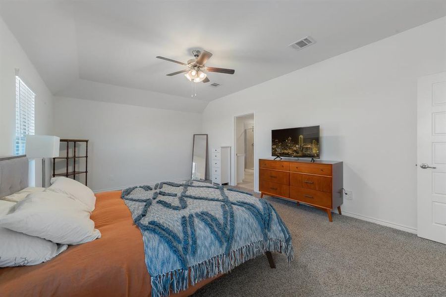 Bedroom featuring baseboards, ceiling fan, visible vents, and light colored carpet