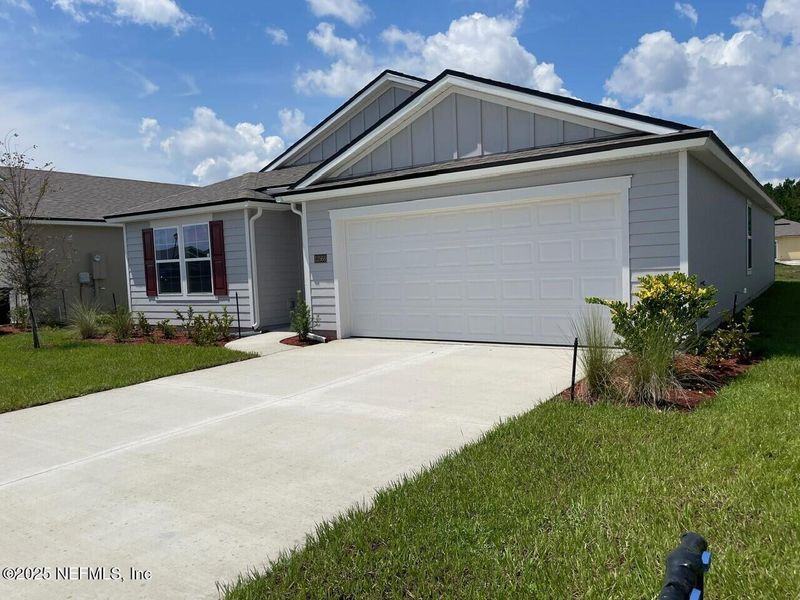 Front exterior of a new home in The Arbors, Jacksonville, FL, highlighting curb appeal (Image 1). Front exterior of a new home in The Arbors, Jacksonville, FL, highlighting curb appeal (Image 1).