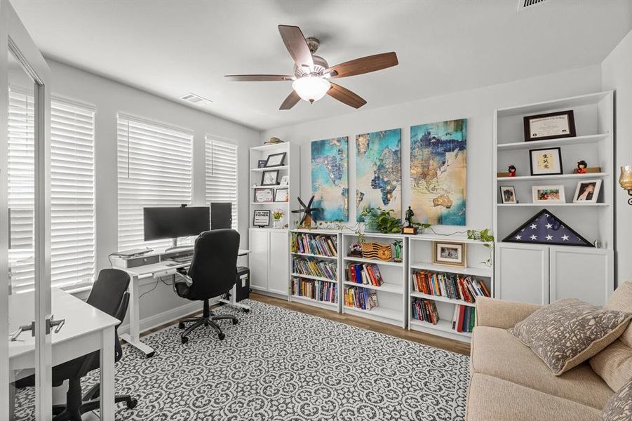 Office area featuring a ceiling fan and light wood finished floors Office area featuring a ceiling fan and light wood finished floors