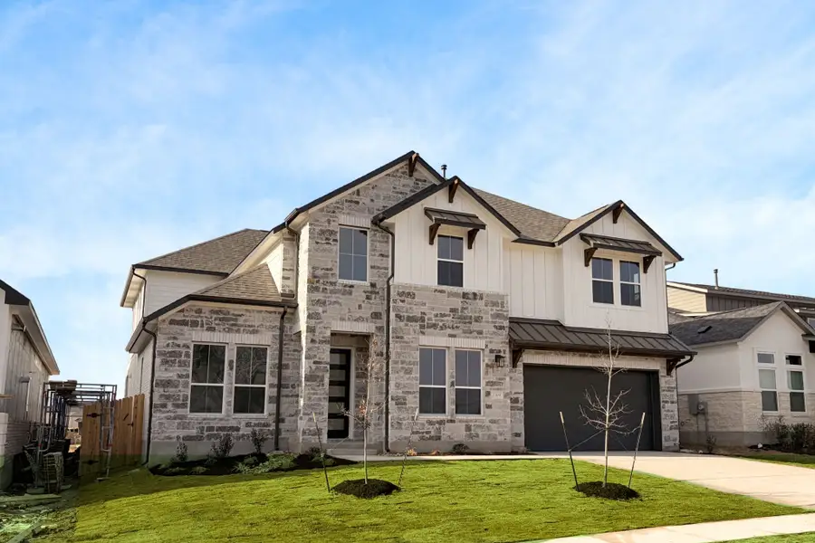 Front exterior of a new home in The Grove at Blackhawk, Pflugerville, TX, highlighting curb appeal (Image 2). Front exterior of a new home in The Grove at Blackhawk, Pflugerville, TX, highlighting curb appeal (Image 2).