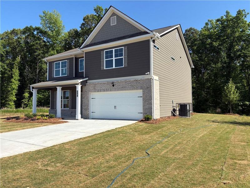Front exterior of a new home in Highland Park, Stonecrest, GA, highlighting curb appeal (Image 3). Front exterior of a new home in Highland Park, Stonecrest, GA, highlighting curb appeal (Image 3).