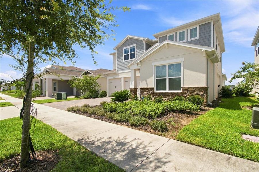 Front exterior of a new home in Horizon Isle, Winter Garden, FL, highlighting curb appeal (Image 26). Front exterior of a new home in Horizon Isle, Winter Garden, FL, highlighting curb appeal (Image 26).