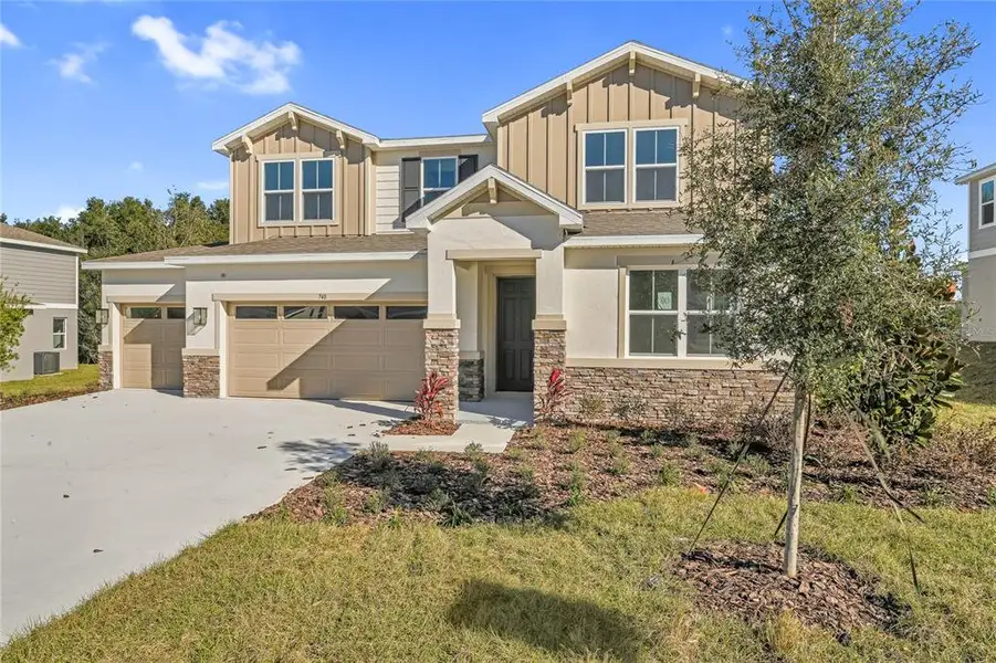 Front exterior of a new home in Seasons at Wekiva Ridge, Mount Dora, FL, highlighting curb appeal (Image 1). Front exterior of a new home in Seasons at Wekiva Ridge, Mount Dora, FL, highlighting curb appeal (Image 1).