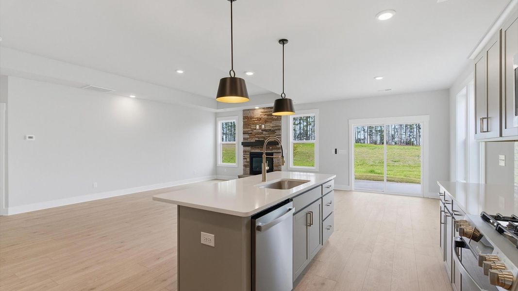Notable kitchen space with elegant pendant lighting and a large island perfect for entertaining