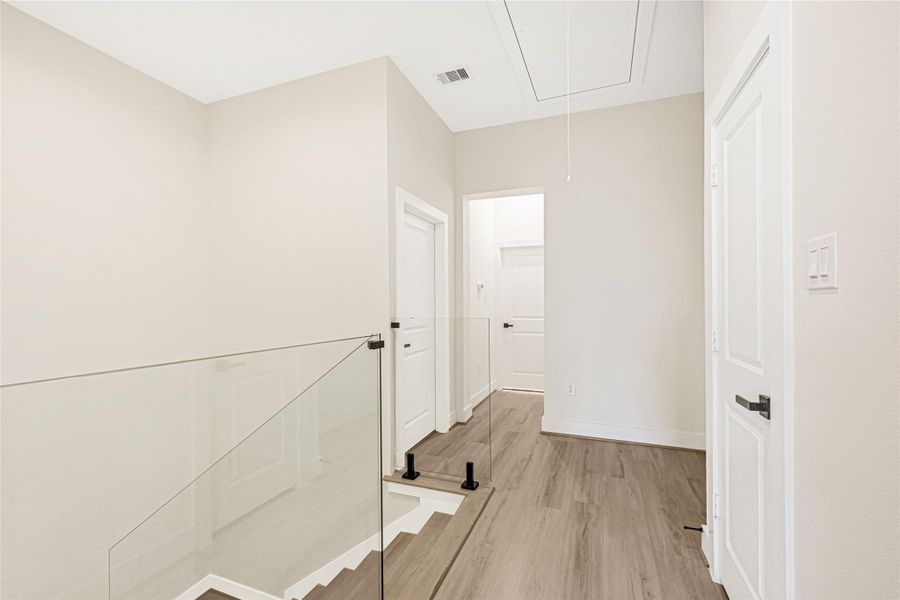 Stairwell is equipped w/ custom glass railings