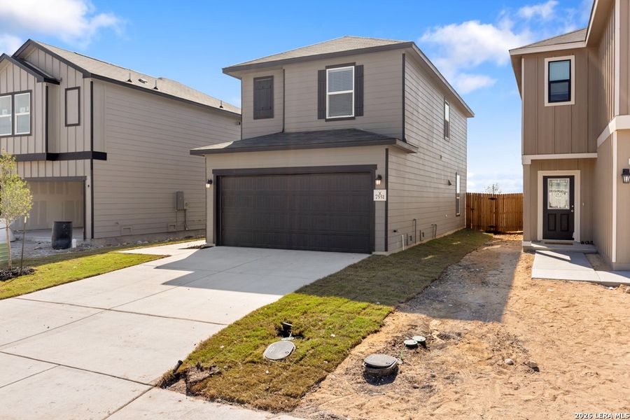 Front exterior of a new home in Preserve at Culebra - Villa Collection, San Antonio, TX, highlighting curb appeal (Image 2). Front exterior of a new home in Preserve at Culebra - Villa Collection, San Antonio, TX, highlighting curb appeal (Image 2).