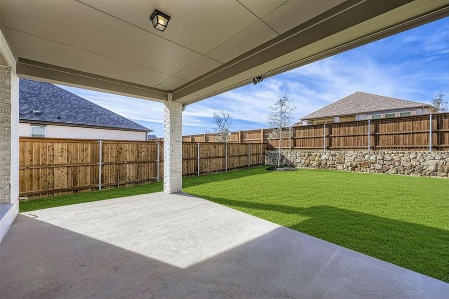 Fenced backyard with a patio area