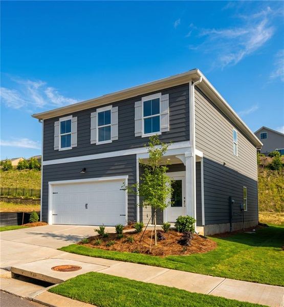 Front exterior of a new home in The Bluffs, Canton, GA, highlighting curb appeal (Image 2). Front exterior of a new home in The Bluffs, Canton, GA, highlighting curb appeal (Image 2).