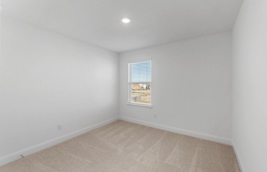 Empty room featuring baseboards and light carpet