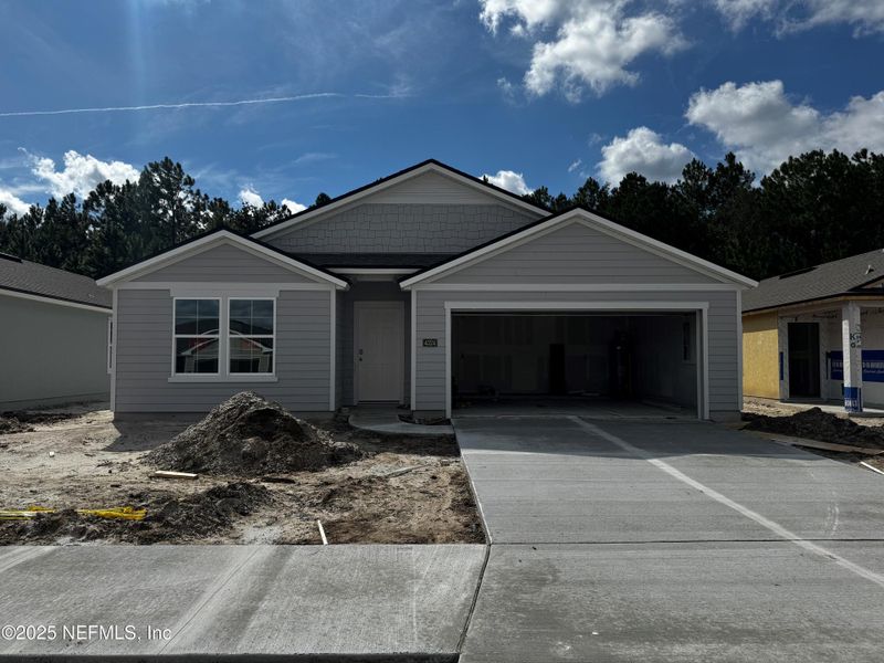 Front exterior of a new home in The Arbors, Jacksonville, FL, highlighting curb appeal (Image 1). Front exterior of a new home in The Arbors, Jacksonville, FL, highlighting curb appeal (Image 1).