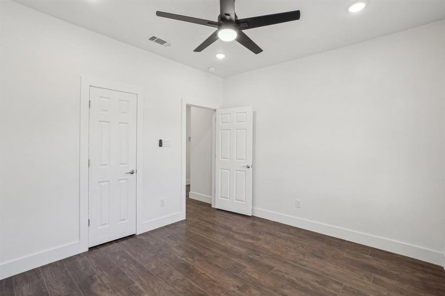 Front bedroom 2 featuring ceiling fan and dark hardwood / wood-style floors