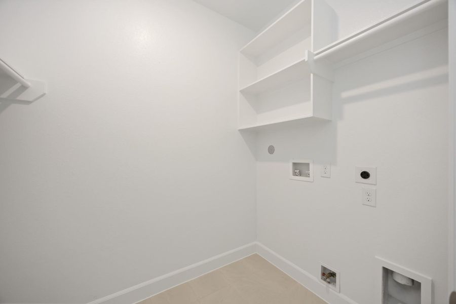Clean design meets clever function in this dedicated laundry room. With built-in shelving and plenty of space to fold, it actually makes chores feel…doable.