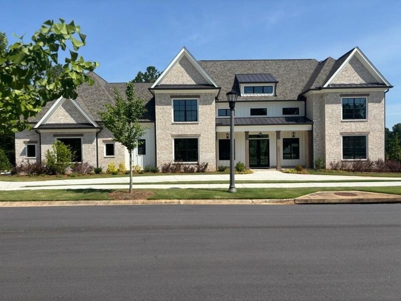 Front exterior of a new home in The Georgia Club, Statham, GA, highlighting curb appeal (Image 1).