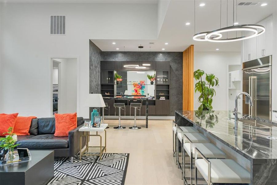 Living room featuring light wood finished floors and recessed lighting Living room featuring light wood finished floors and recessed lighting