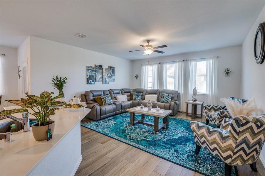 Living room featuring hardwood / wood-style floors and ceiling fan