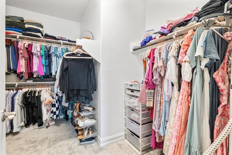 Walk in closet featuring light colored carpet Walk in closet featuring light colored carpet
