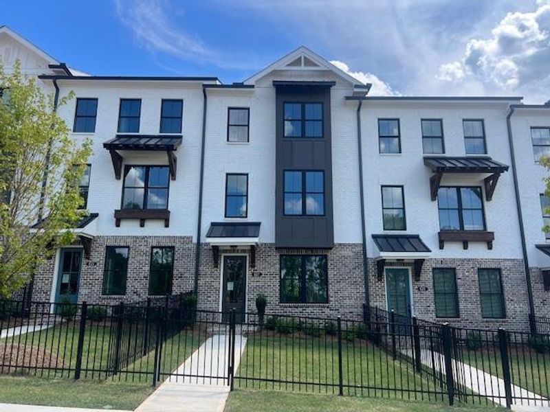 Front exterior of a new home in Palisades Townhomes, Cumming, GA, highlighting curb appeal (Image 20).