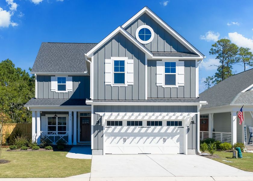 Front exterior of a new home in Carolina Creek, Hampstead, NC, highlighting curb appeal (Image 1).