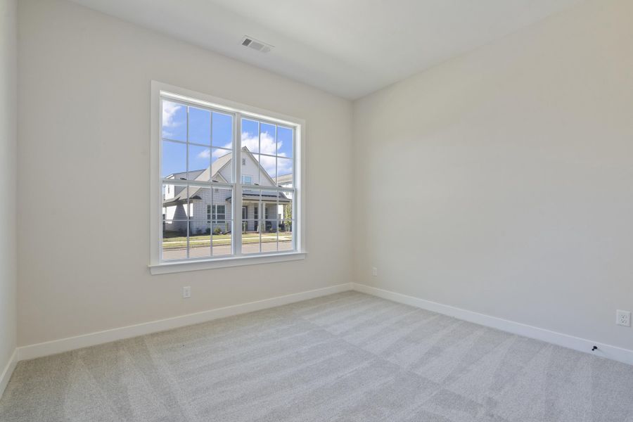 Empty room with light carpet and baseboards Empty room with light carpet and baseboards