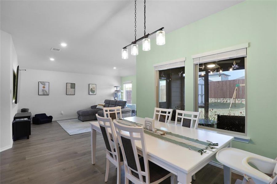 Dining area with recessed lighting and dark wood-style flooring