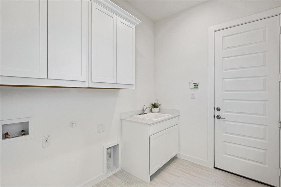 Laundry room featuring cabinets, washer hookup, gas dryer hookup, and sink