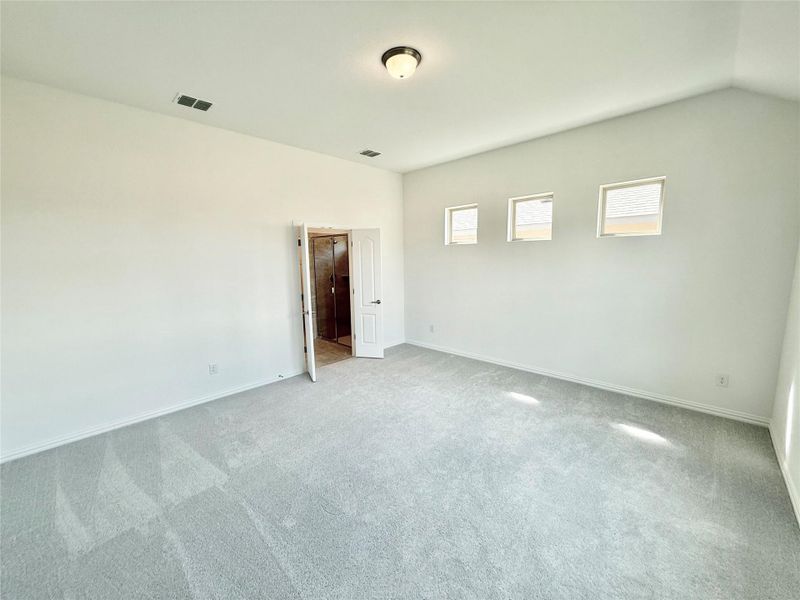 Spare room featuring carpet floors and baseboards Spare room featuring carpet floors and baseboards