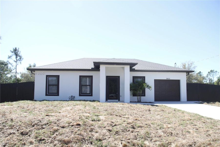 Front exterior of a new home in , Lehigh Acres, FL, highlighting curb appeal (Image 1).