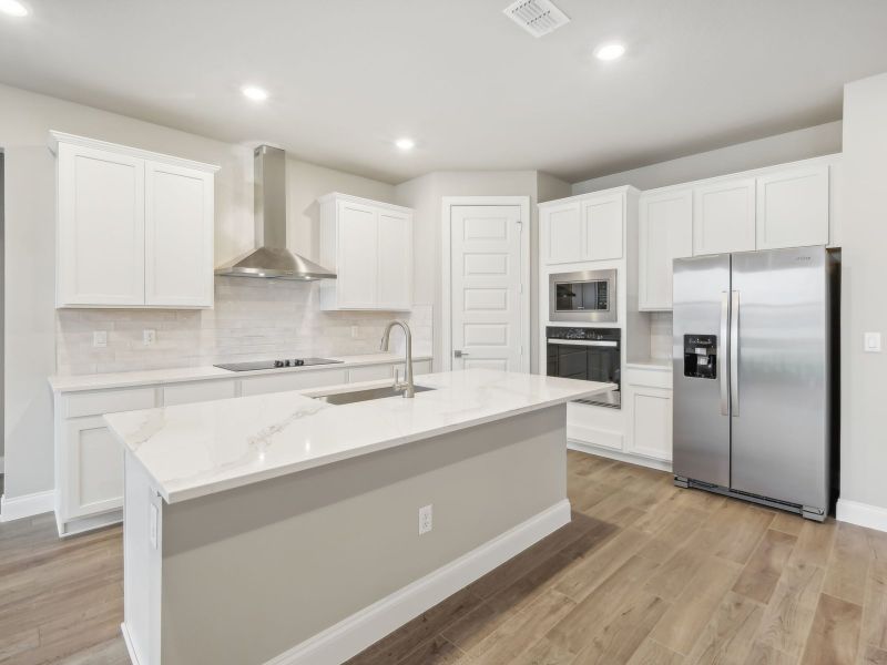 Kitchen in the Coral floorplan at 6398 NW Sweetwood Dr