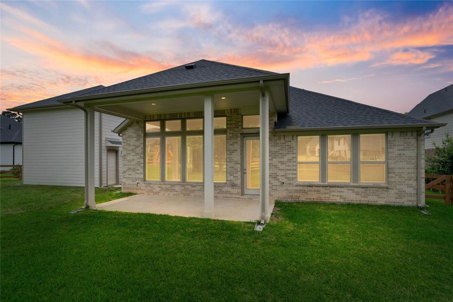 This expansive covered patio provides a fantastic outdoor living space, perfect for relaxing or entertaining year-round. The generous concrete area is supported by sturdy columns, and a wall of large windows and glass doors creates a seamless indoor-outdoor connection. This expansive covered patio provides a fantastic outdoor living space, perfect for relaxing or entertaining year-round. The generous concrete area is supported by sturdy columns, and a wall of large windows and glass doors creates a seamless indoor-outdoor connection.