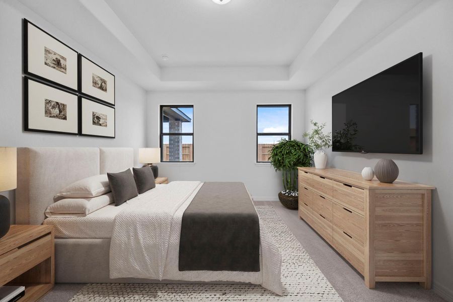The primary bedroom with tray ceiling is a restful retreat, layered with warmth, light, and rustic elegance.