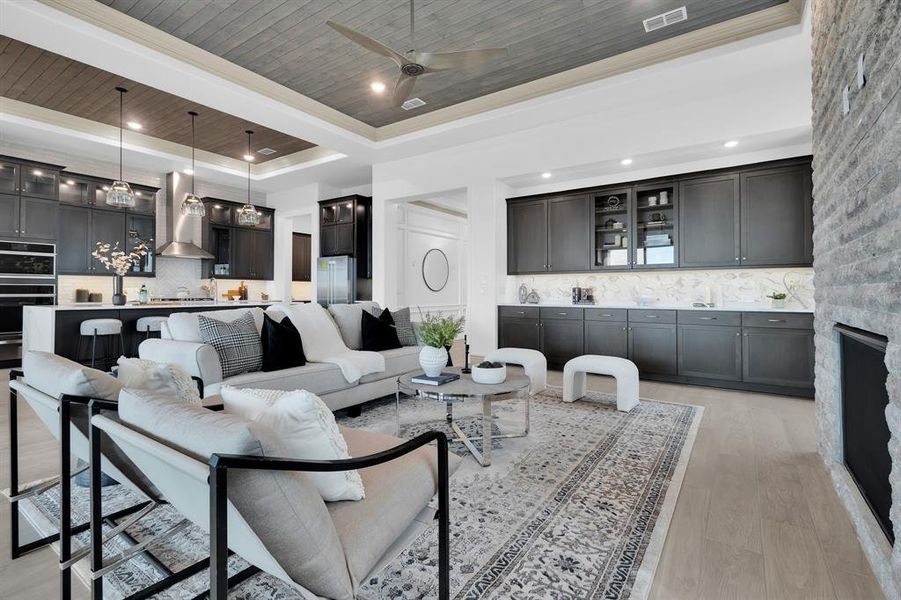 Living area with wooden ceiling, light wood finished floors, a tray ceiling, ceiling fan, and recessed lighting