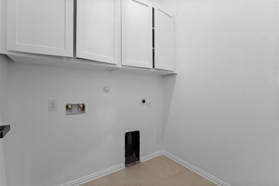 Washroom featuring cabinet space, electric dryer hookup, hookup for a gas dryer, and washer hookup Washroom featuring cabinet space, electric dryer hookup, hookup for a gas dryer, and washer hookup