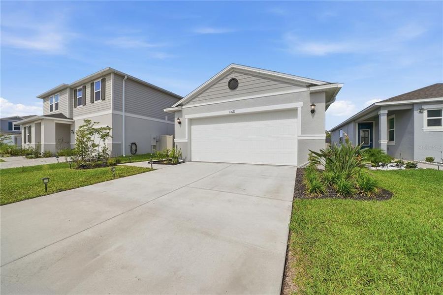 Front exterior of a new home in Magnolia Creek, Riverview, FL, highlighting curb appeal (Image 25). Front exterior of a new home in Magnolia Creek, Riverview, FL, highlighting curb appeal (Image 25).