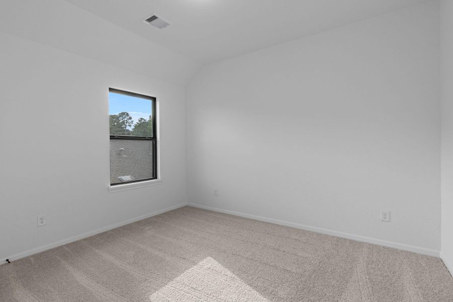 Your secondary bedroom features plush carpet, fresh paint, closet, and a large window that lets in plenty of natural lighting.