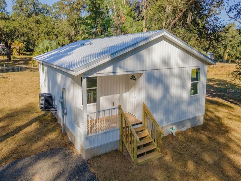 Exterior details and patio area of a home in , Fort McCoy (Image 15).