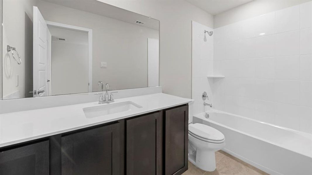 Full bath featuring vanity,  shower combination, and light tile patterned floors