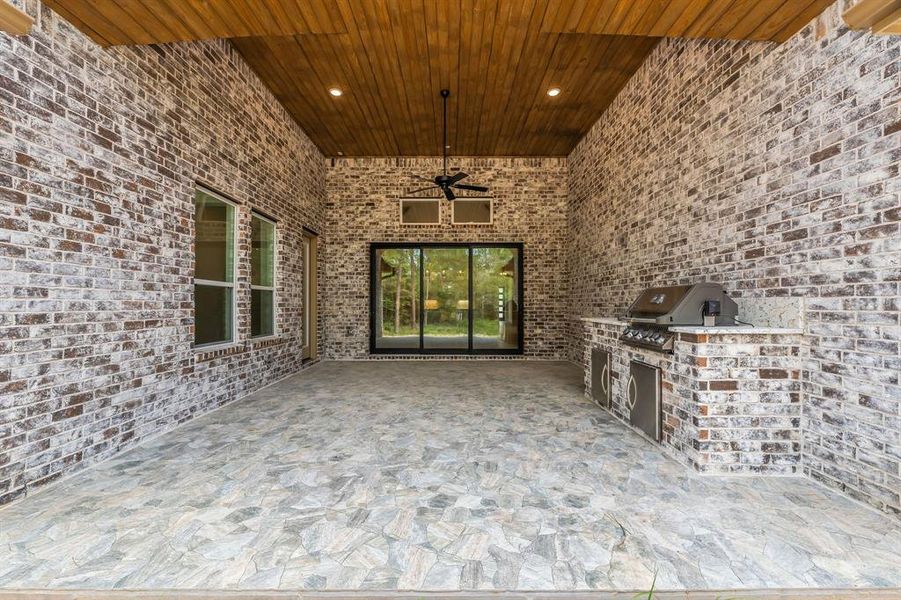 Covered patio with built-in outdoor kitchen! With dual access, from game room or sliding glass doors from living area