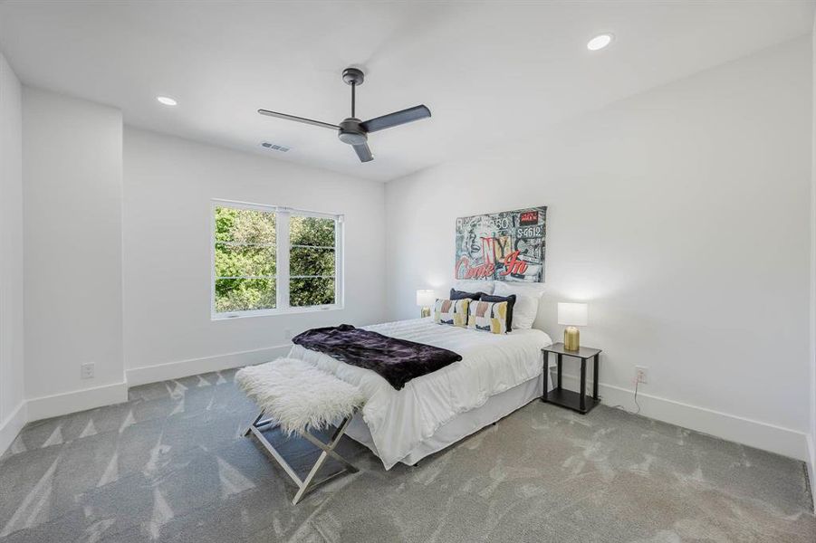 Carpeted bedroom featuring ceiling fan and recessed lighting Carpeted bedroom featuring ceiling fan and recessed lighting