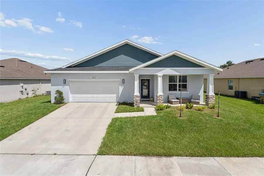 Front exterior of a new home in , Kissimmee, FL, highlighting curb appeal (Image 1). Front exterior of a new home in , Kissimmee, FL, highlighting curb appeal (Image 1).