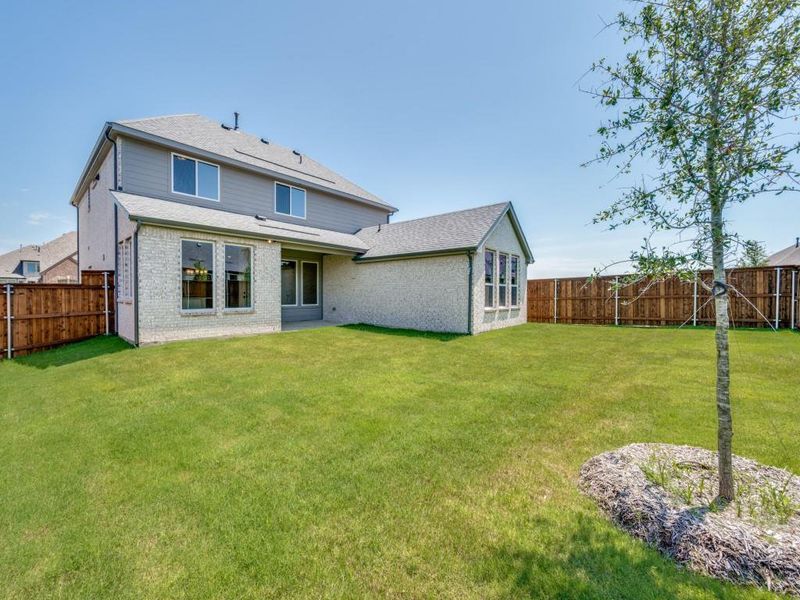 You'll find a spacious, fenced back yard offering ample space for outdoor family fun time in this beautiful home!