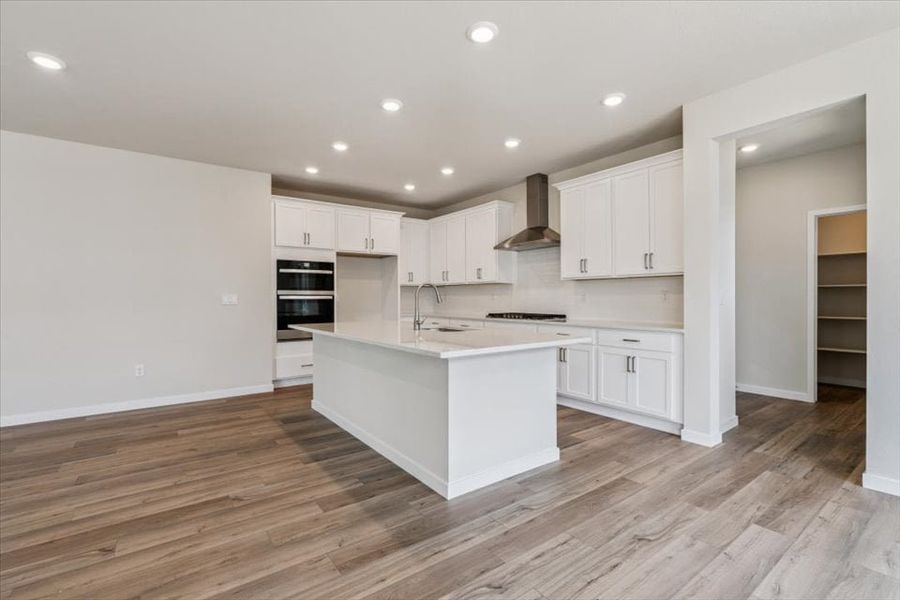 A kitchen with white cabinets.