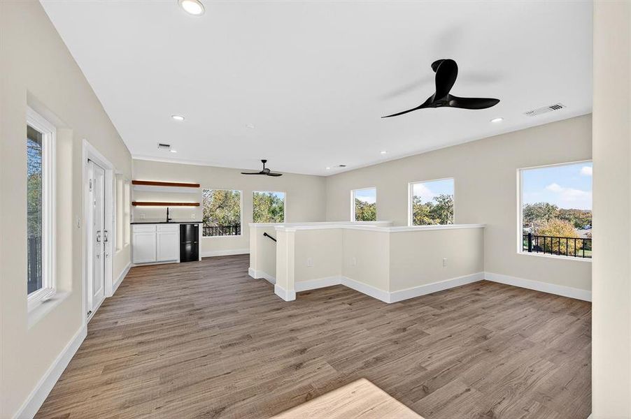 Unfurnished room featuring light wood finished floors, ceiling fan, and recessed lighting
