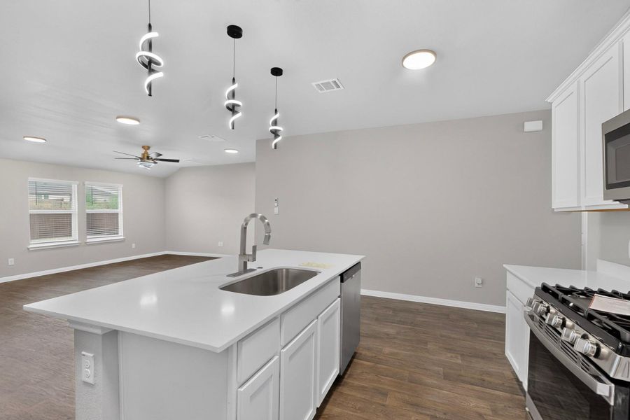 An open floorplan seamlessly connects the kitchen to the adjoining living space.